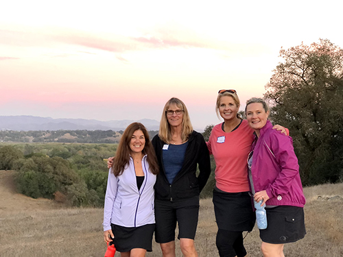A group of four women posing outside on one of our retreats in Sonoma