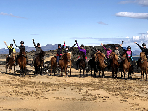 Women horseback riding on the beaches in Iceland