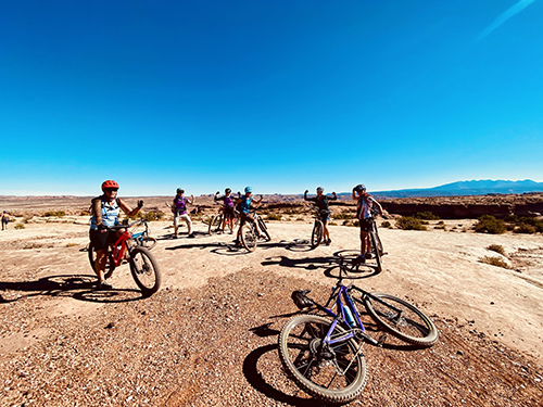 Women's Quest biking on a yoga retreat Utah