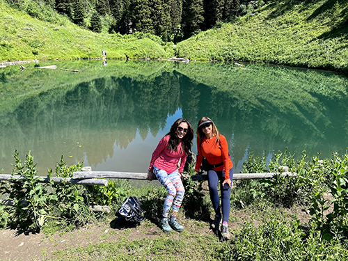 Two women posing outside on a hiking trail 