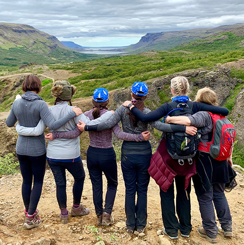A group of women on a horseback riding retreat in Iceland posing for a picture