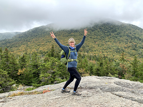 Woman hiking in Vermont on a Women's Quest retreat