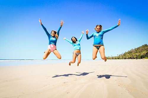 Jumping for joy during our women's surf camp Costa Rica
