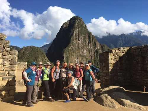 Women posing in front of a mountain in Peru