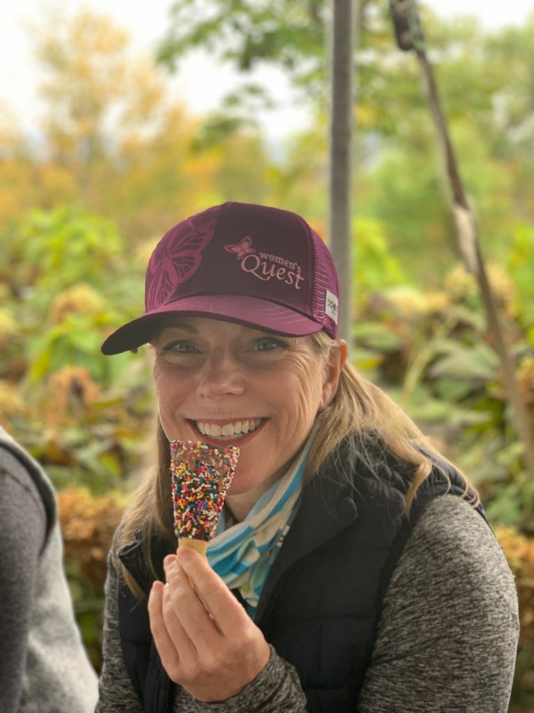 Woman smiling on with an ice cream cone on the Women's Quest Vermont retreat.