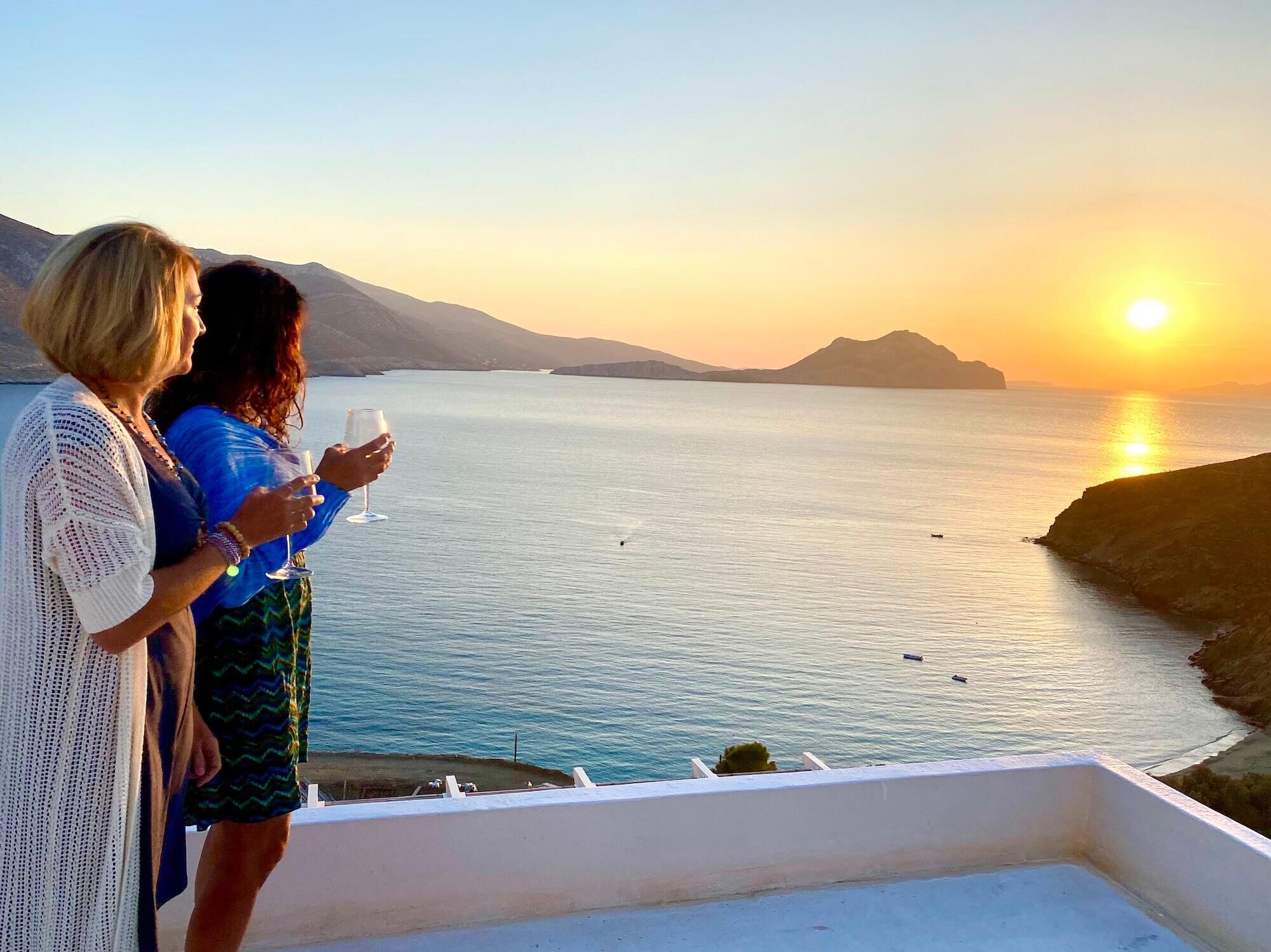 Two women viewing sunset in Amorgos Greece