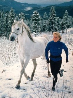 Colleen Cannon running with a white horse