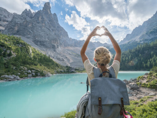 Woman making heart hands on Dolomites adventure retreat